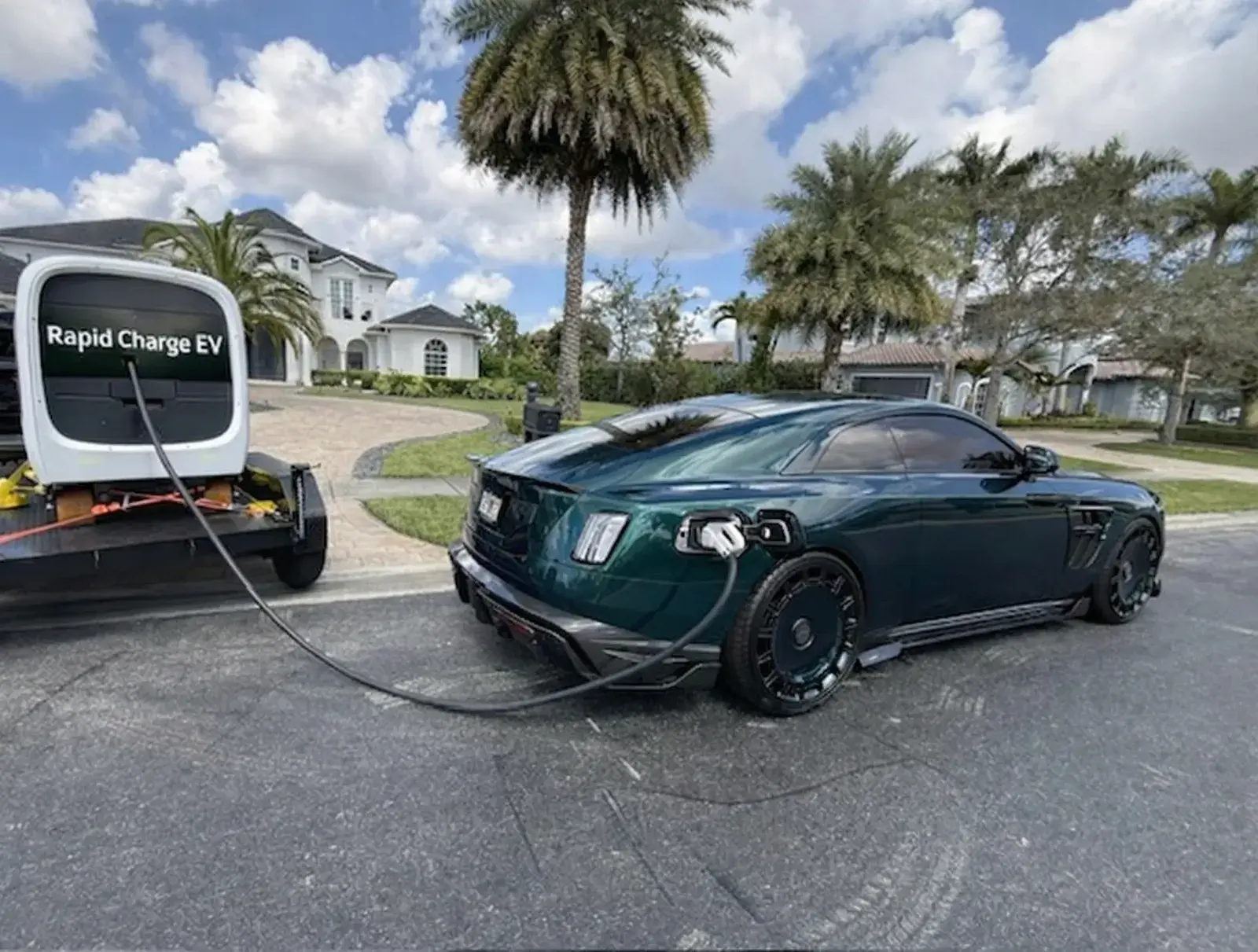 Rapid Charge EV mobile charging unit servicing a luxury EV at a residential property in Miami-Dade County, South Florida